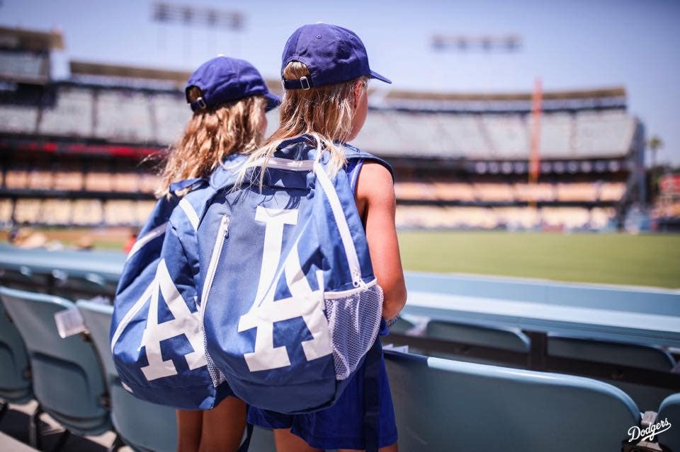 Girls wearing LA Dodgers backpacks at Dodger Stadium