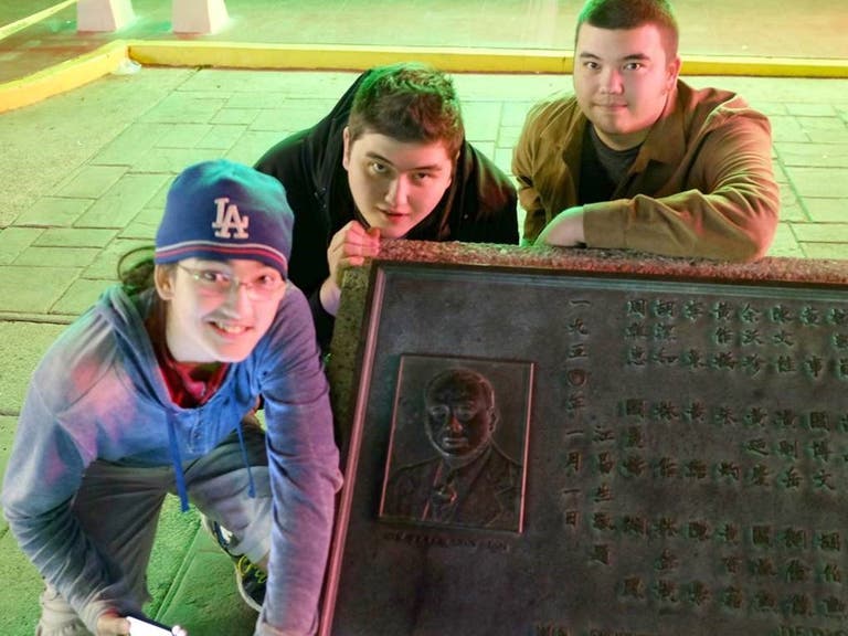 Jon SooHoo's sons with their great-grandfather's plaque in Chinatown
