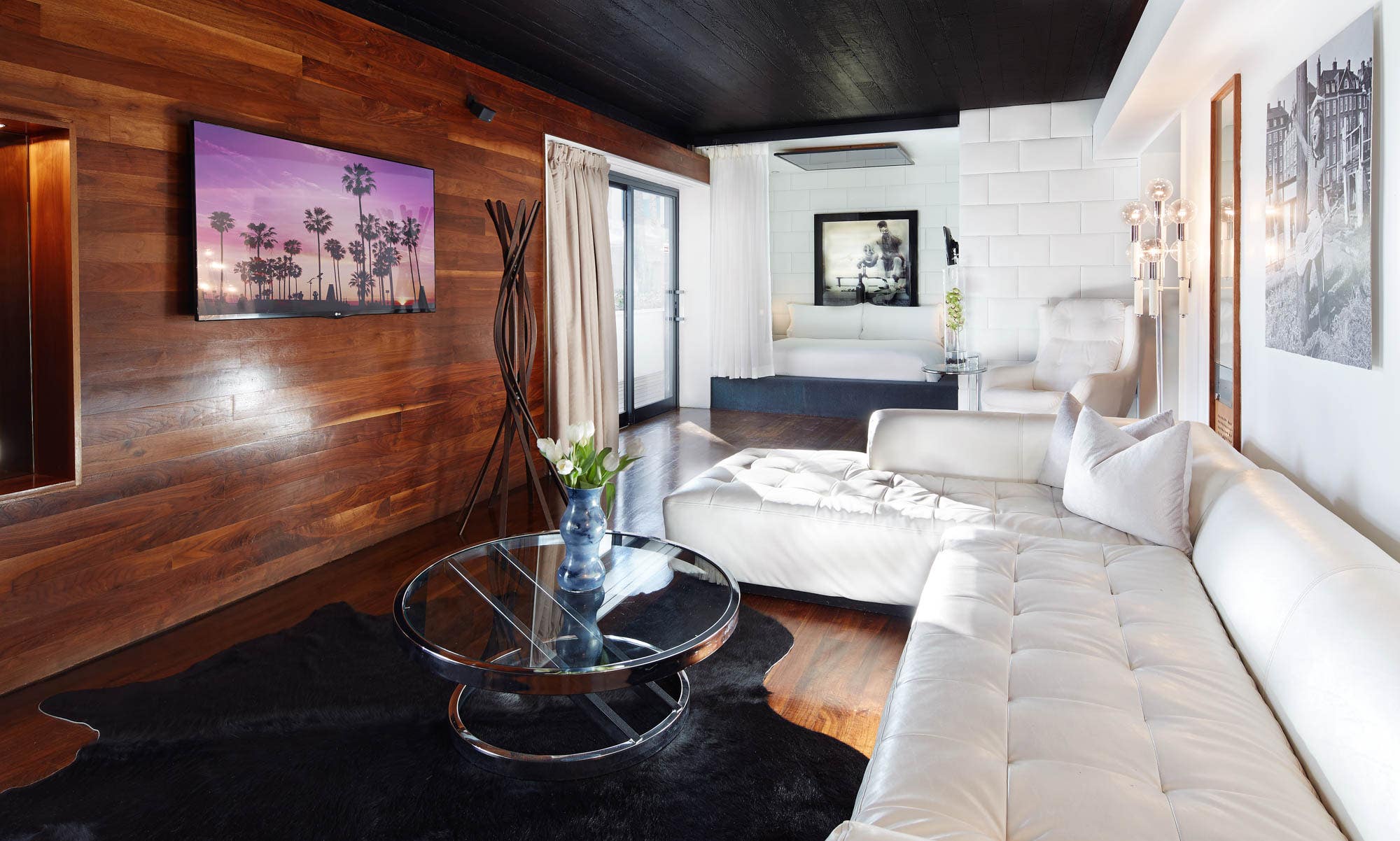 Interior photo of the Hollywood Roosevelt's Marilyn Monroe Suite with wood walls and white couch