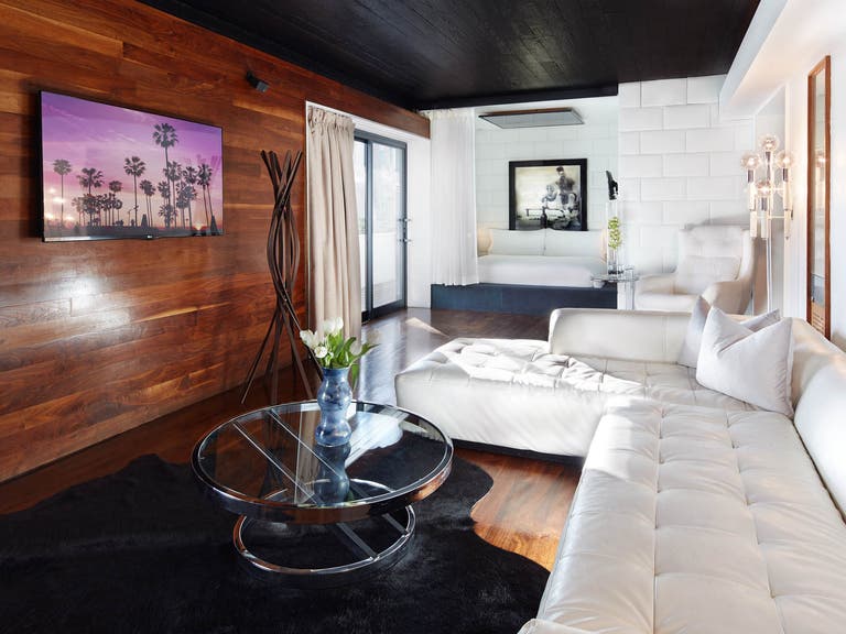 Interior photo of the Hollywood Roosevelt's Marilyn Monroe Suite with wood walls and white couch