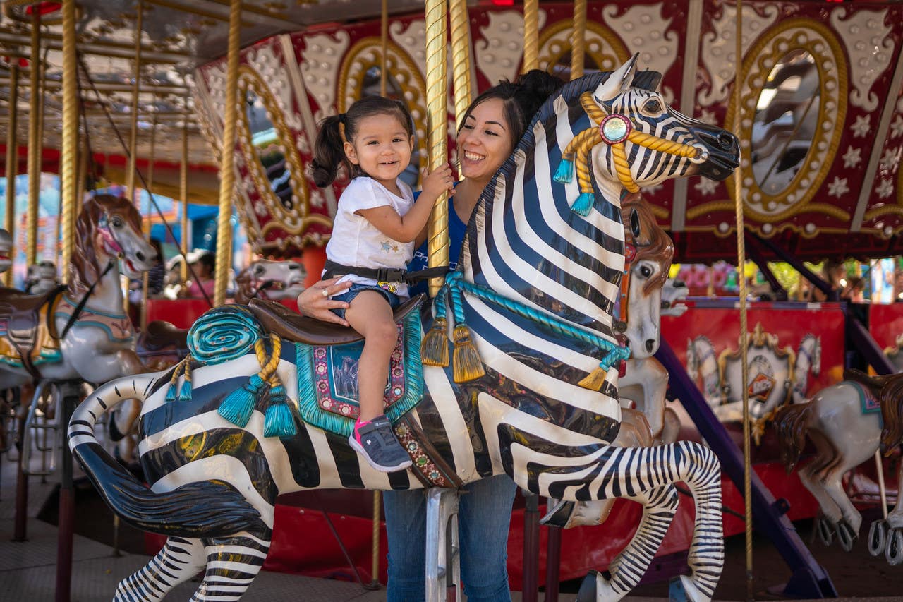 Mother and daughter ride the carousel at the LA County Fair