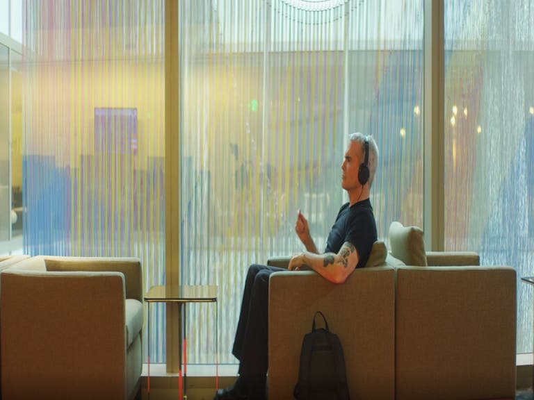 Henry Rollins relaxes with headphones in the Executive Lounge at LAX