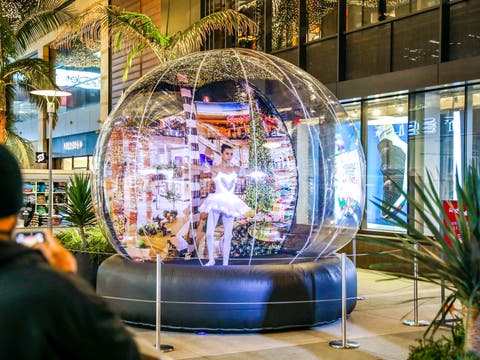 A ballerina performs inside the Holiday Snow Globe at Santa Monica Place