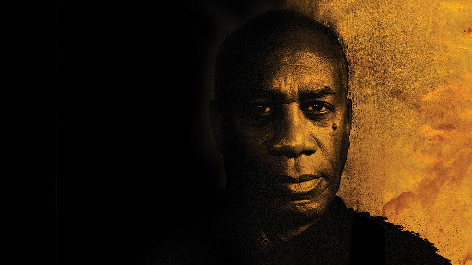 Joe Morton in front of a black and yellow background