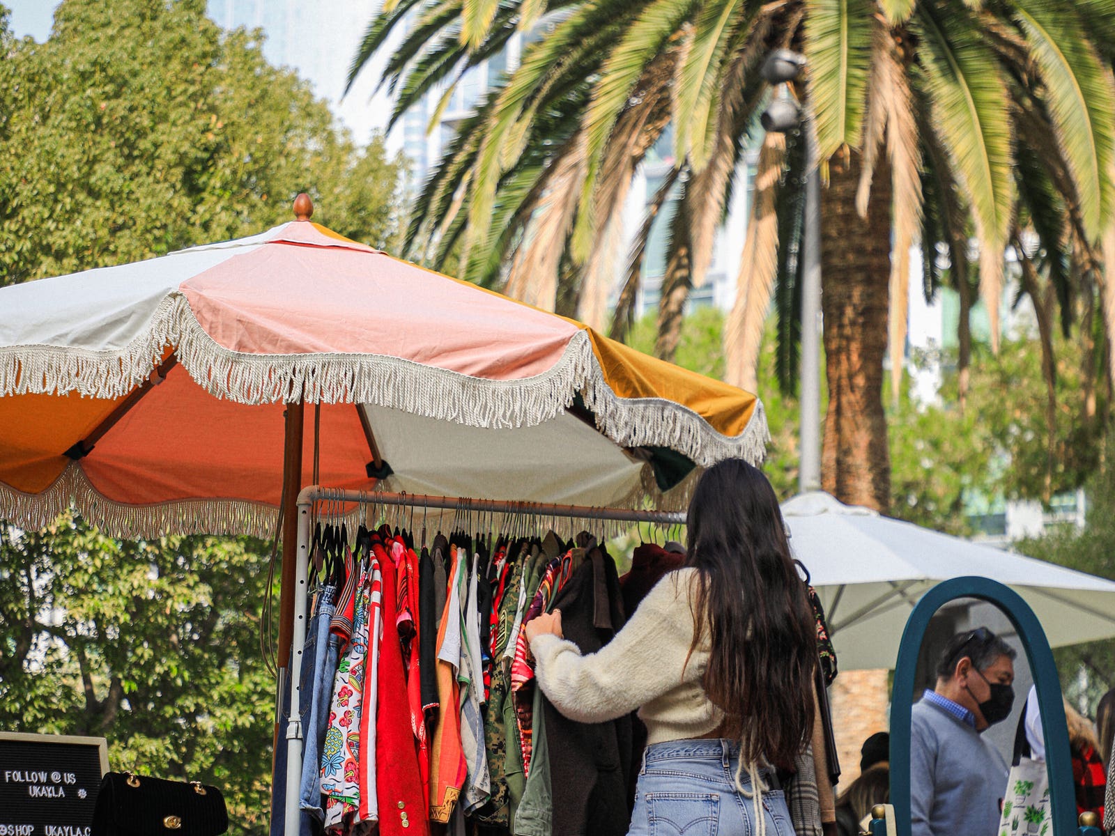 Shoppers examine clothing racks at the FIDM Holiday Market