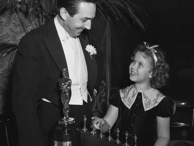 Shirley Temple presents Walt Disney with an Honorary Oscar at the 11th Academy Awards