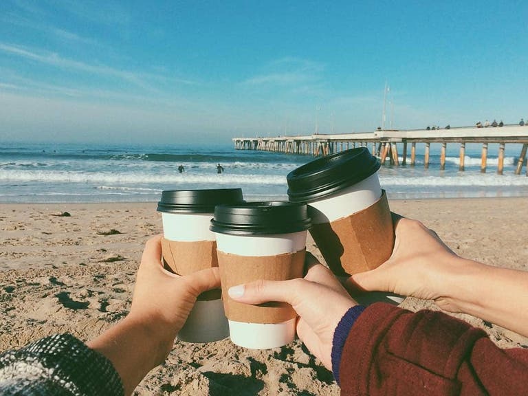 Coffee on the beach from The Cow's End l Instagram by @washingtonsquarevenice
