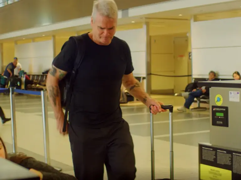 Henry Rollins packs light and weighs his luggage at Tom Bradley International in LAX