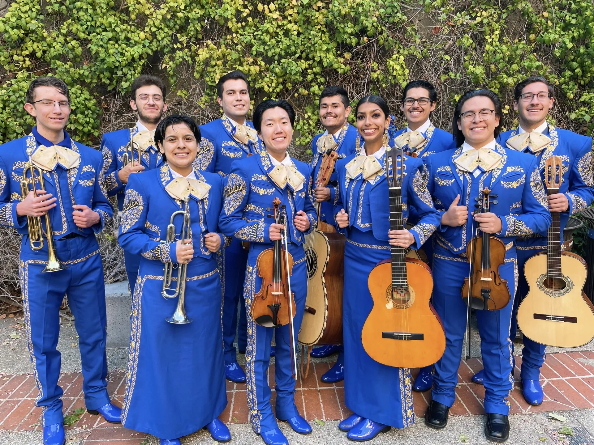 UCLA's Mariachi band dressed in blue holding their instruments and smiling