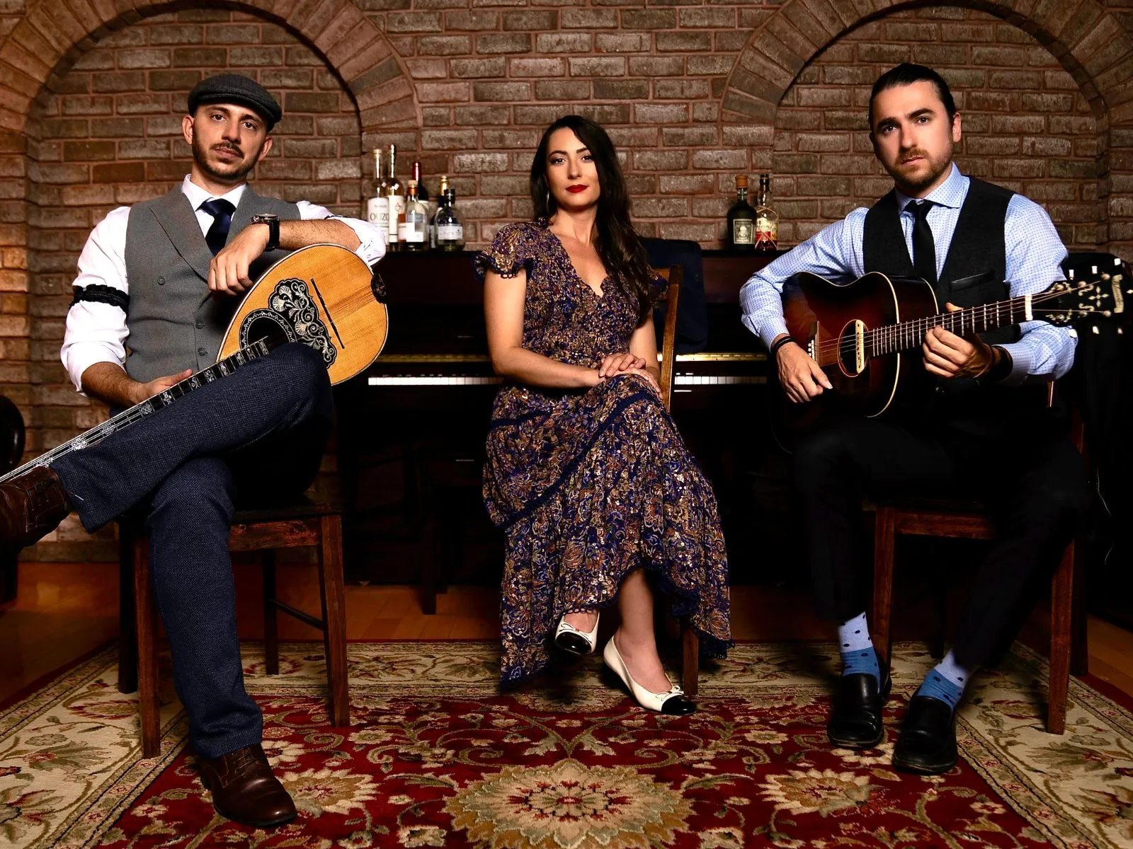 Members of Greek Rebetiko posing for picture with instruments. 