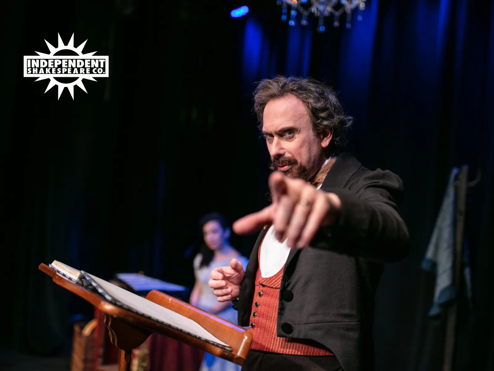 A man in Victorian dress points directly at you.