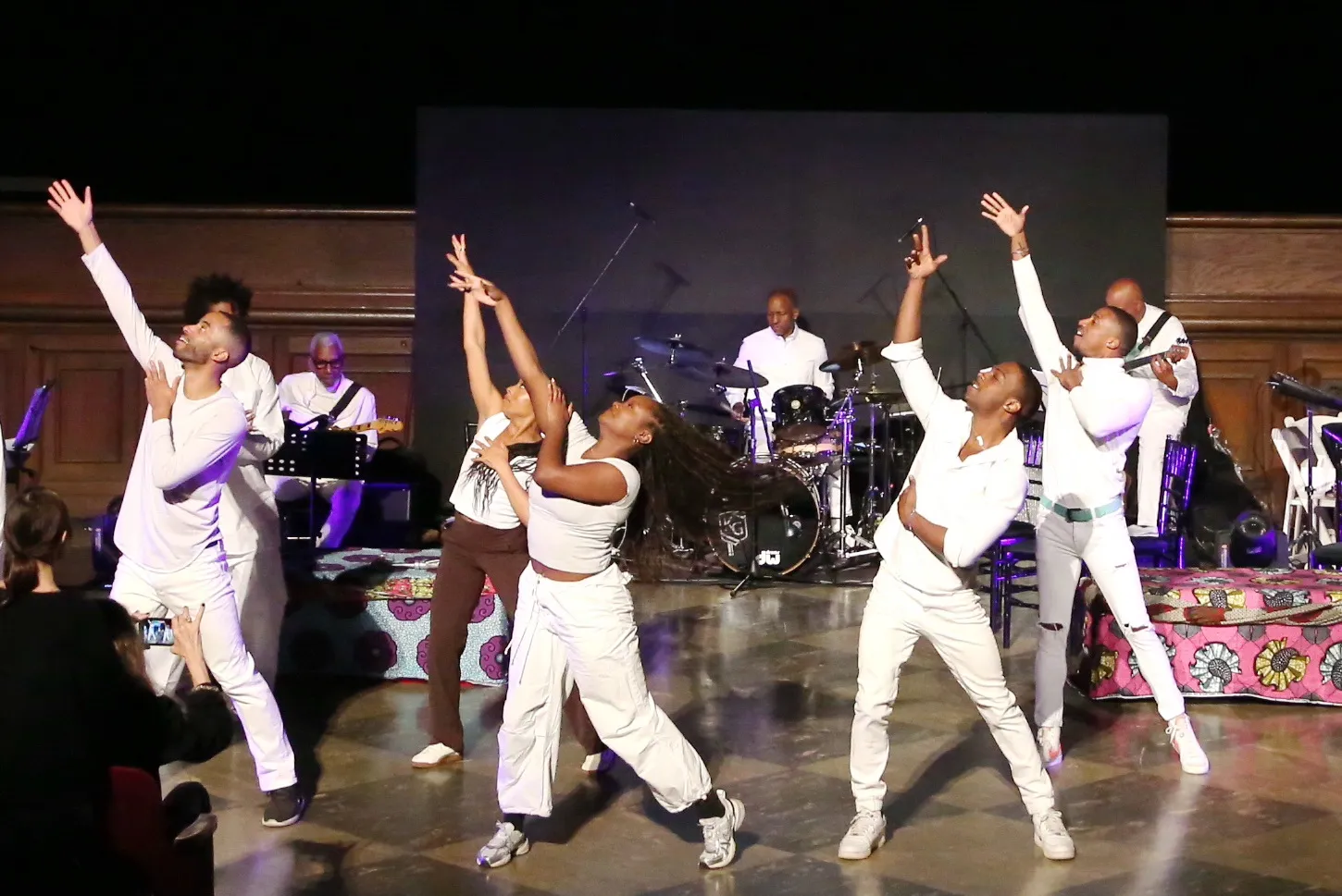 dancers dressed in white perform in front of a band in Forest Lawn's Black History Month Event