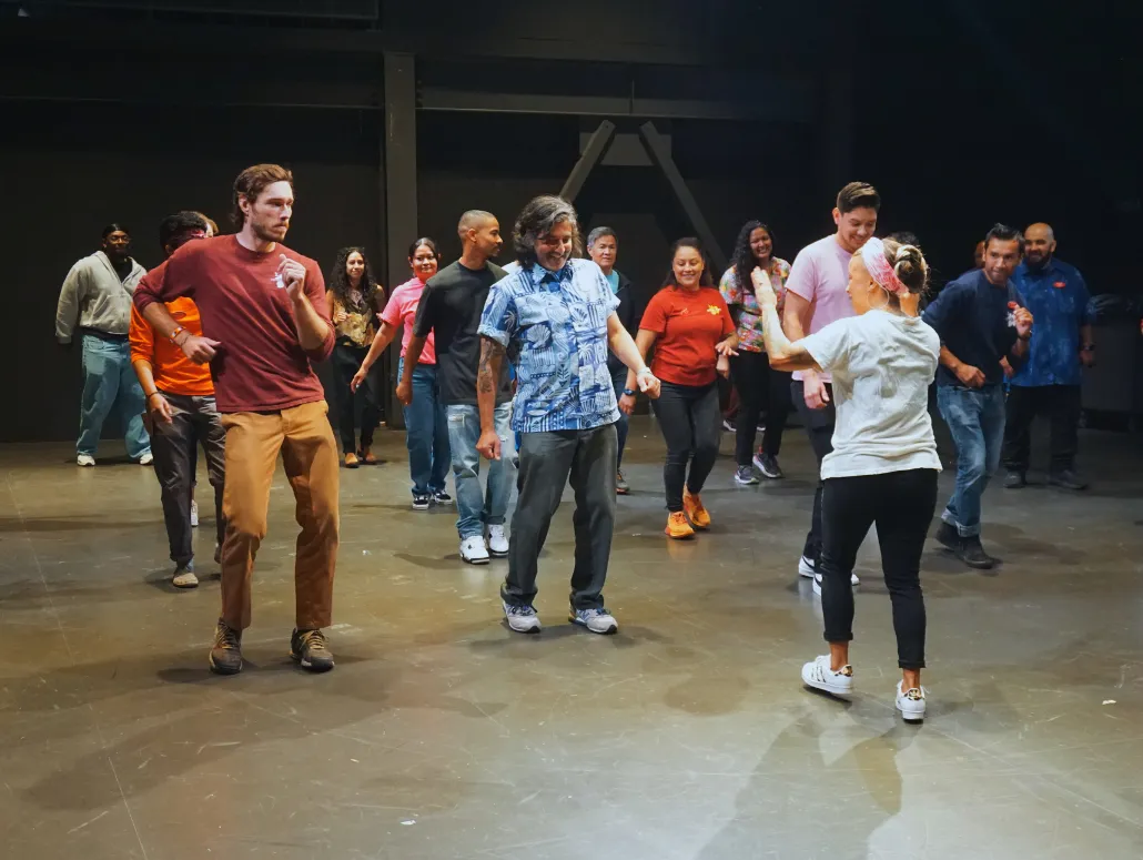 woman leading group of people in a dance routine