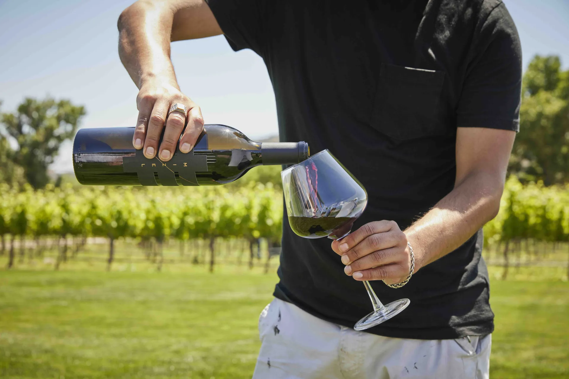 Man Pouring Wine in Mizel Estate Vineyard