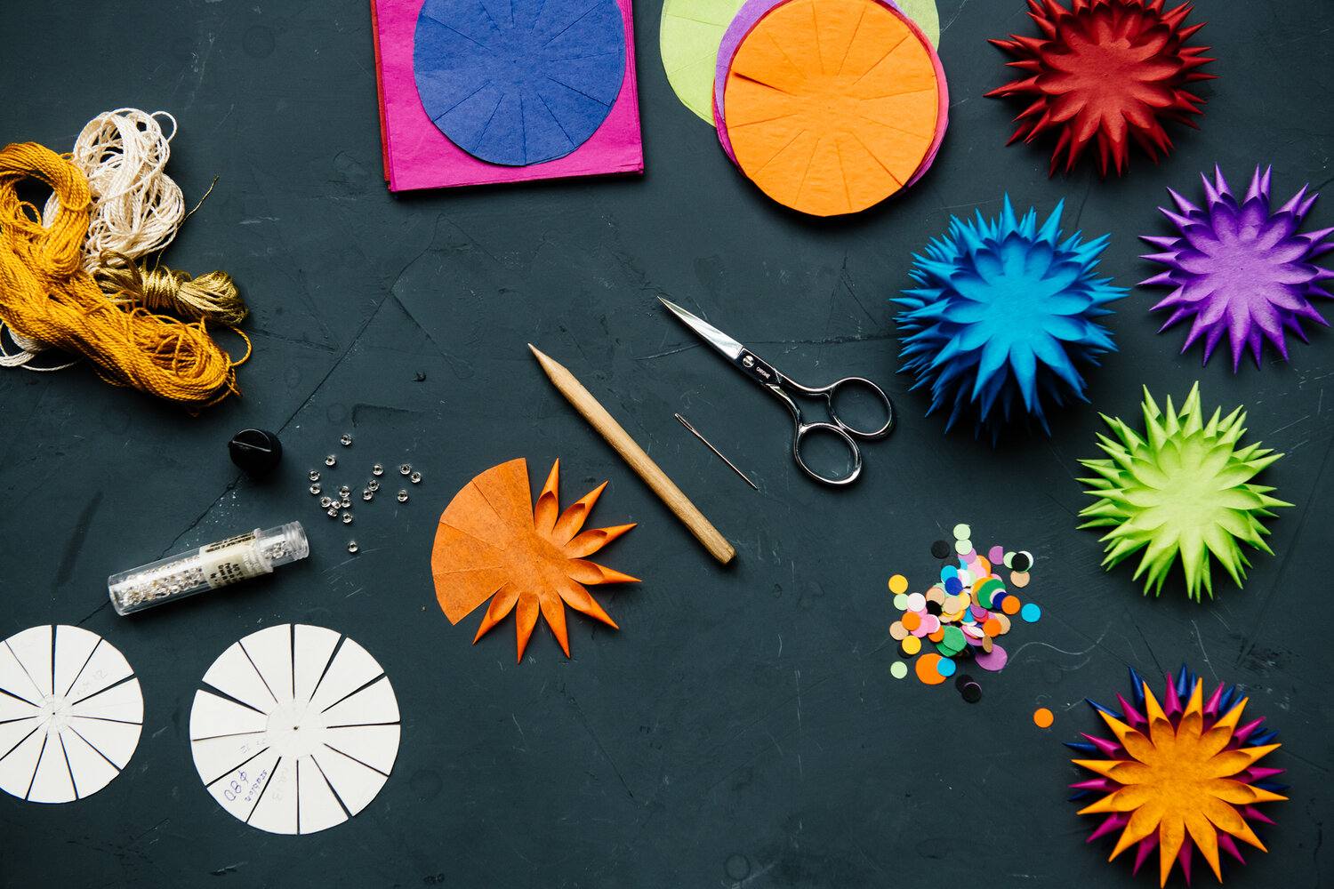 Images of the tools and materials used to create delicate paper ornaments.