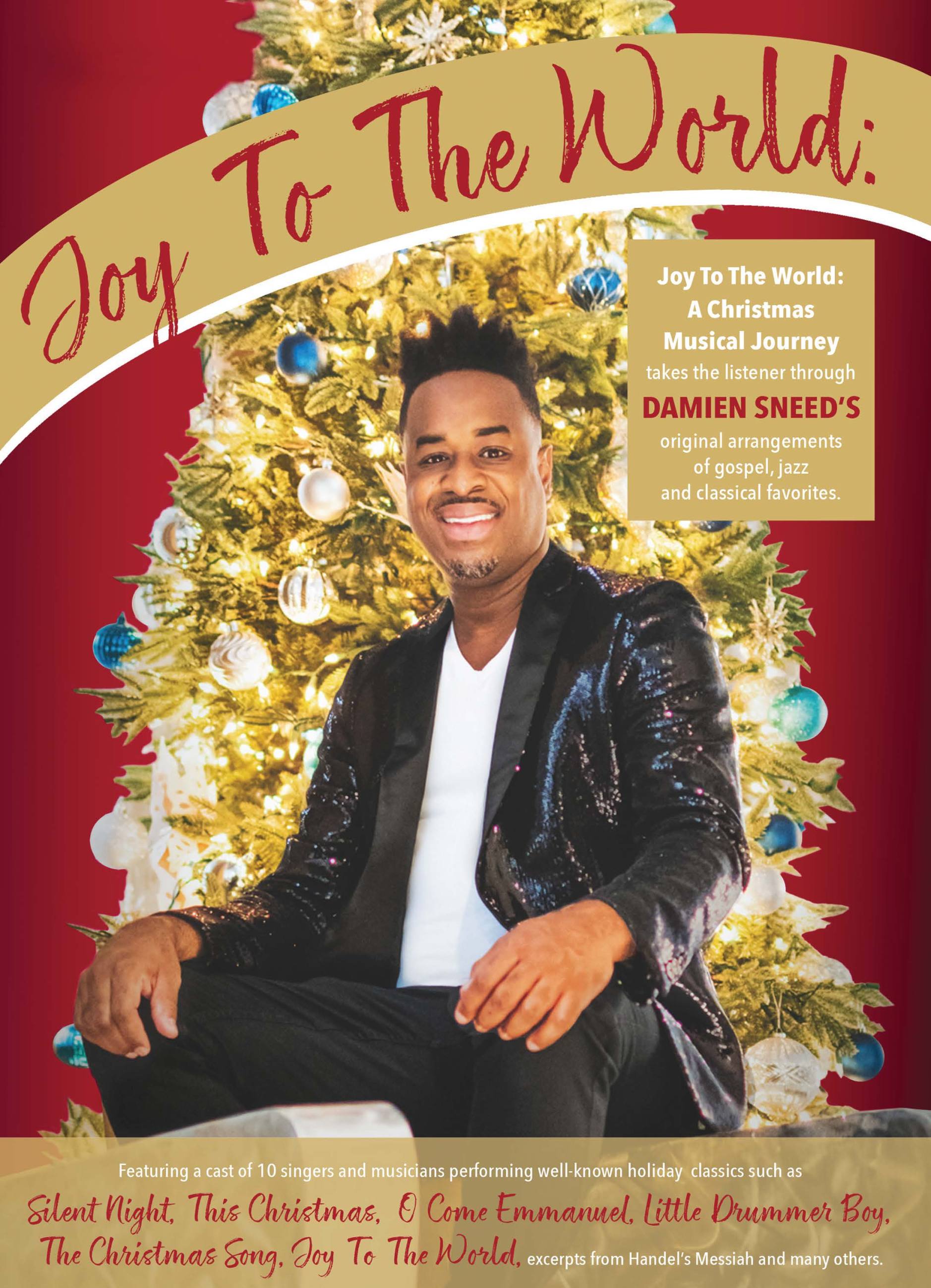 Damien Sneed sits in front of a lit Christmas tree with blue ornaments and a red backdrop. Text on the top of the image reads: Joy to the World