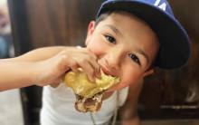 A young Dodgers fan enjoys a French Dip at Philippe the Original