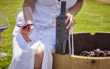 Woman Seated on Wine Barrel with Mizel Estate Wine