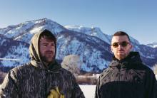 The Chainsmokers (Alex Pall and Drew Taggart) standing together in the snow, photographed for their new EP, No Hard Feelings